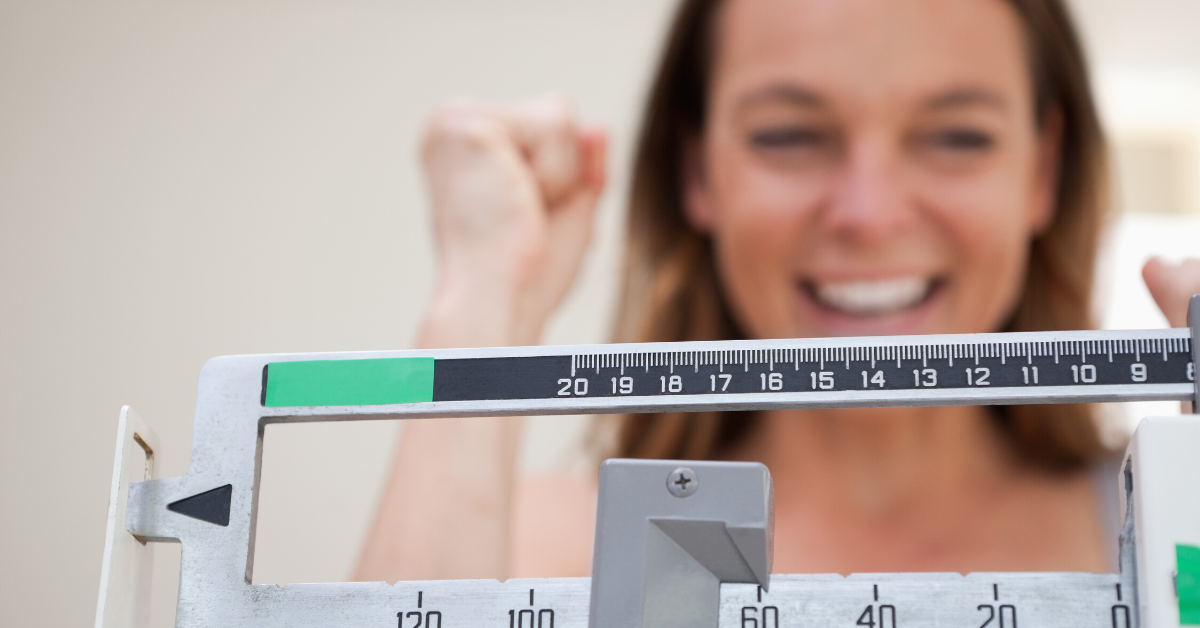 happy woman weighing self