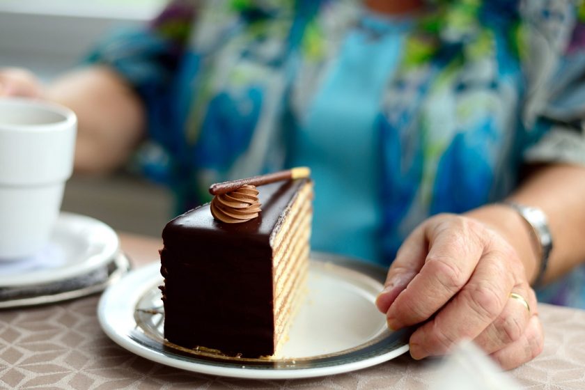 unhealthy lady reaching for cake